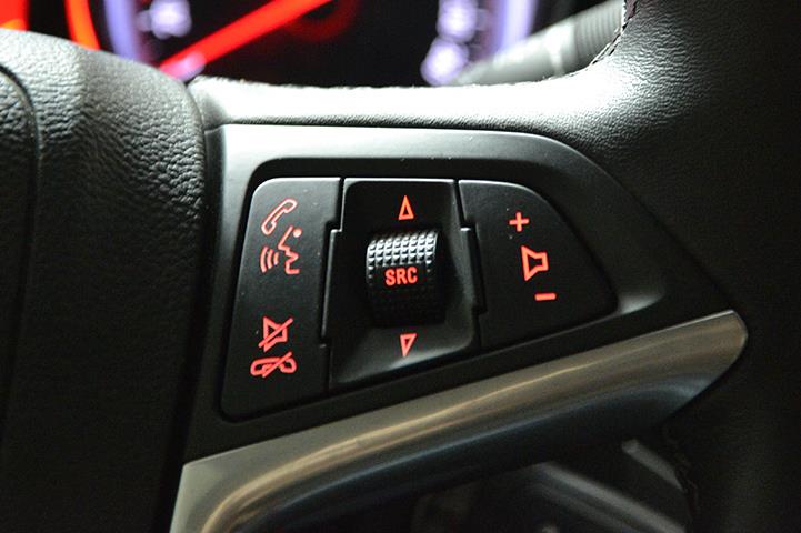 closeup of car steering wheel with controls