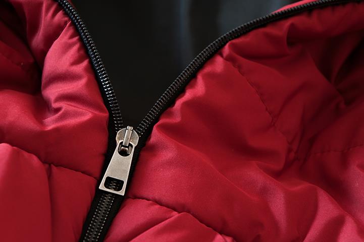 closeup of red partially unzipped down jacket
